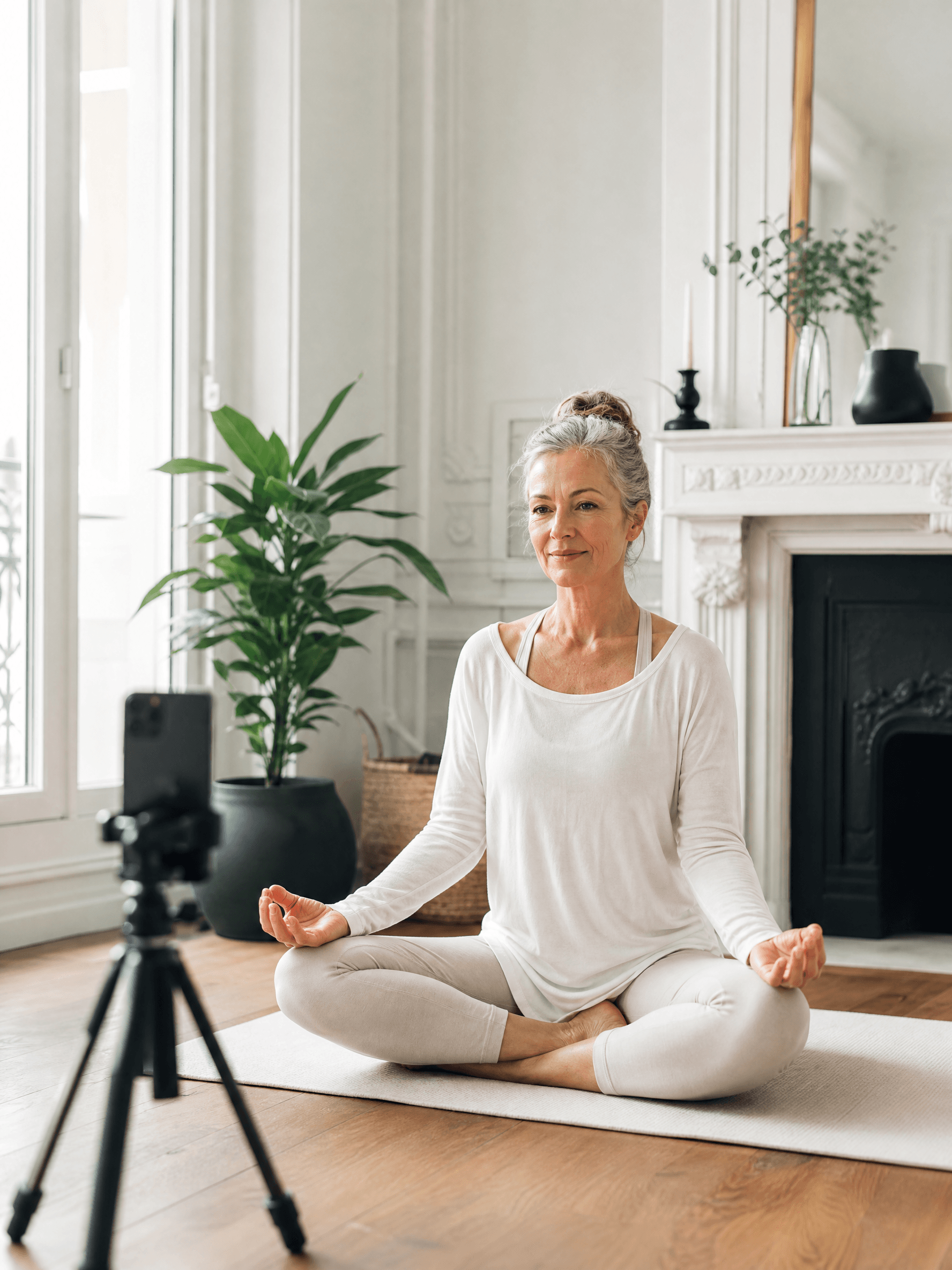 Créatrice bien-être en posture de yoga assise, filmée par son téléphone